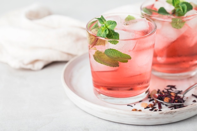 red tea karkade sparkling cold in glasses with mint