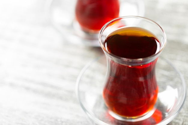 Red tea in turkish glasses on a wooden table