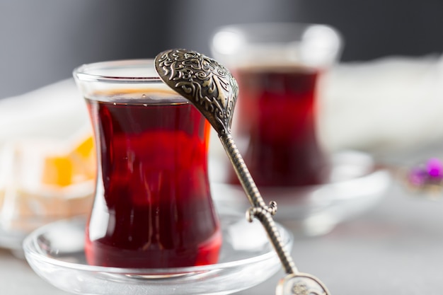 Red tea in turkish glasses on a wooden table