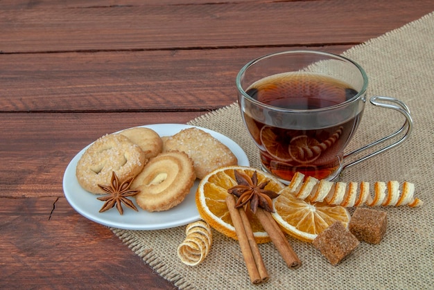 Red tea with butter cookies on a rustic wooden board