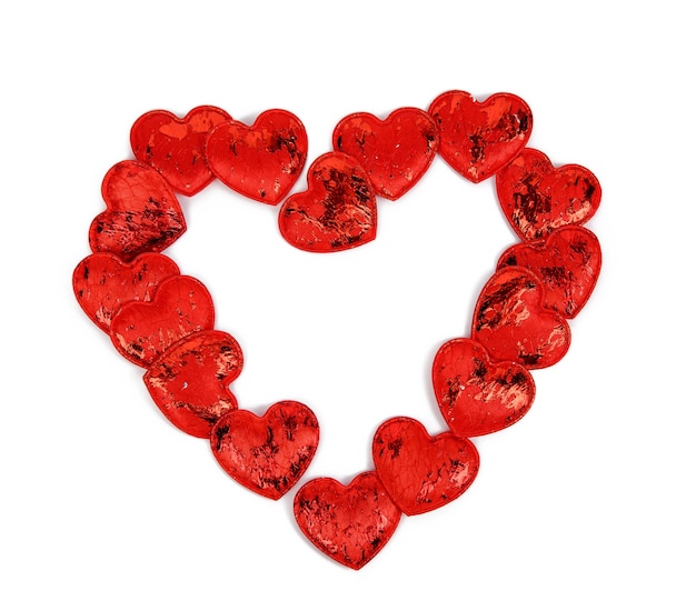 Red textile small hearts on a white background, festive background, shape heart