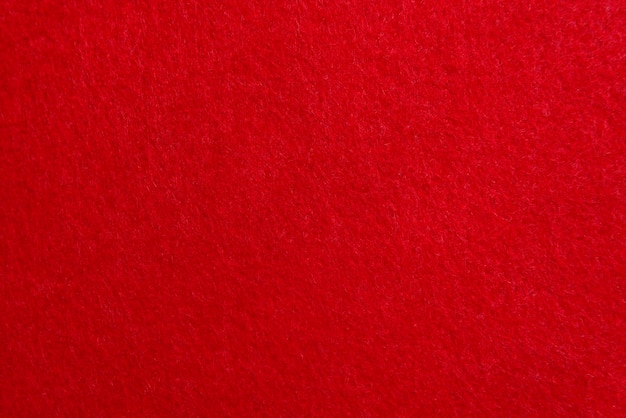 Red texture velour or felt cloth closeup Natural or artificial sewing material Fabric as background for design