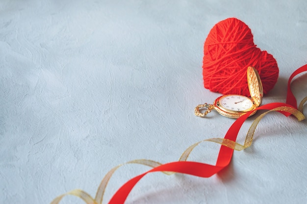 Red thread heart, gold pocket watch