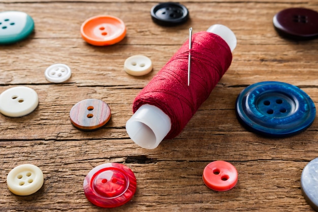 Red thread with a needle on the   buttons