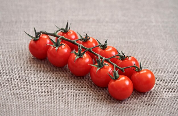 Red tomato on beige background