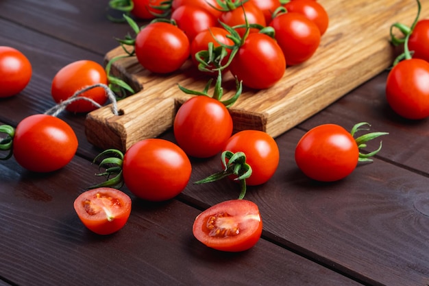 Red tomato in glass bowl on cutting board on wooden table Organic healthy food Cooking Ingredients