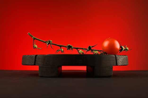 Red tomato on a red background