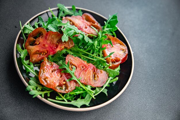 red tomato salad arugula healthy meal food snack on the table copy space food background rustic