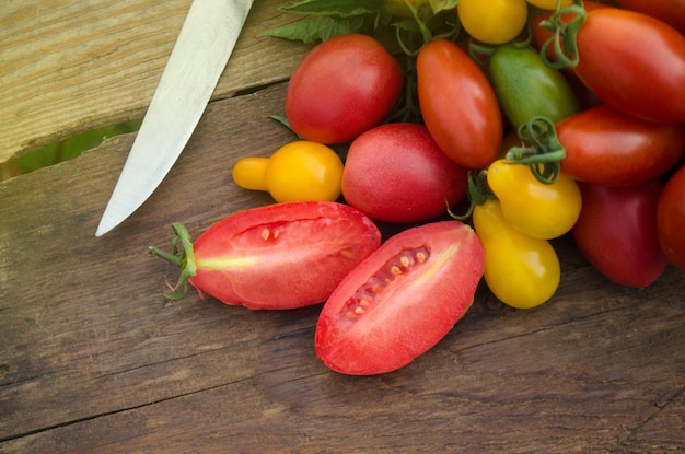 Red tomato on the table Many tomatoes on wooden table