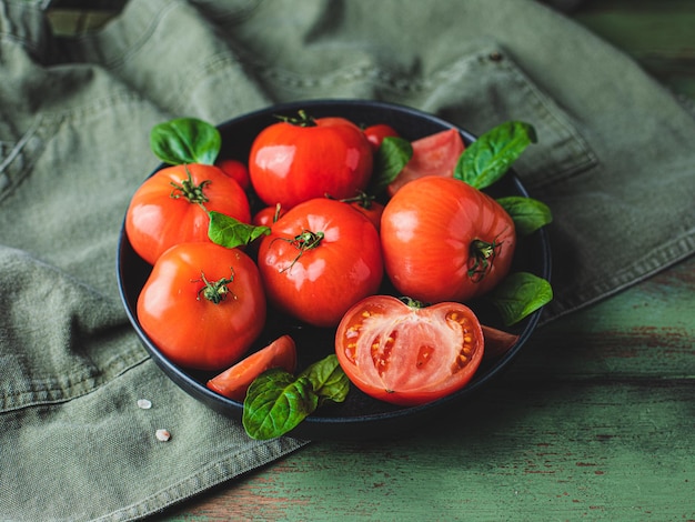 Red tomato vegetable in a bowl on a table 
