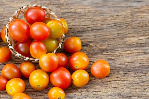 Red tomato on wooden table.