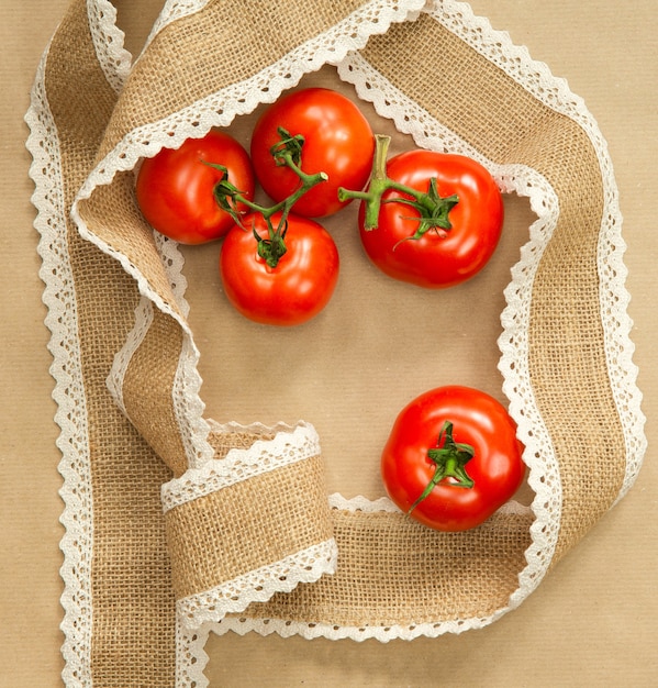 Red Tomatoes on brown craft with burlap ribbon