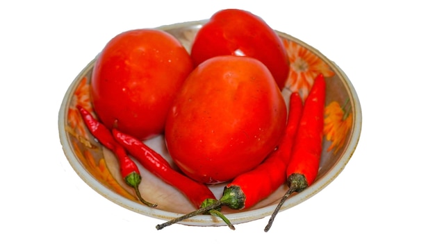 Red tomatoes and chilies in a small bowl