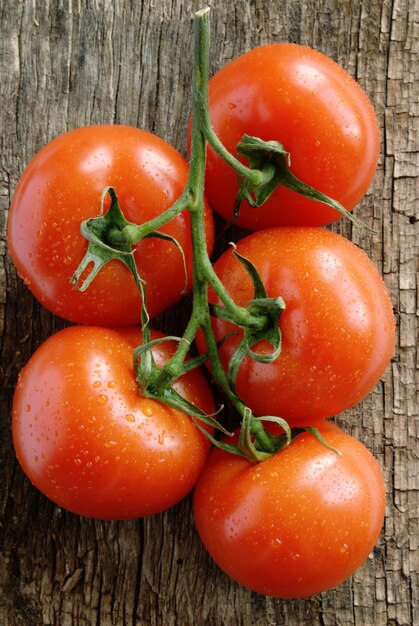 Red tomatoes on the old board