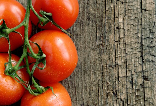 Red tomatoes on the old board