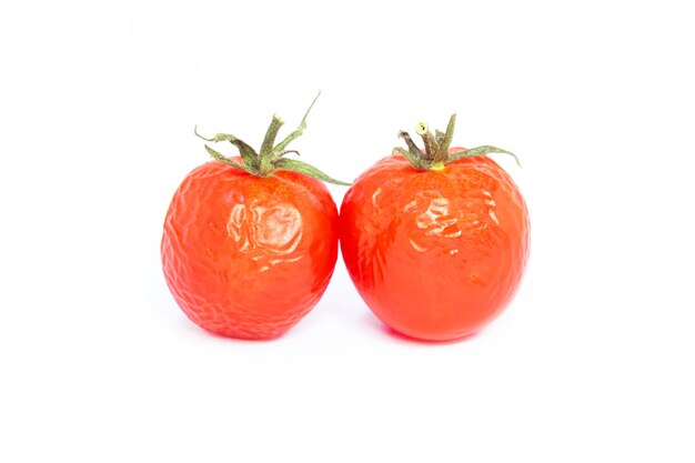 Red tomatoes on white background. Healthy food for good healt. Withered tomatoes.