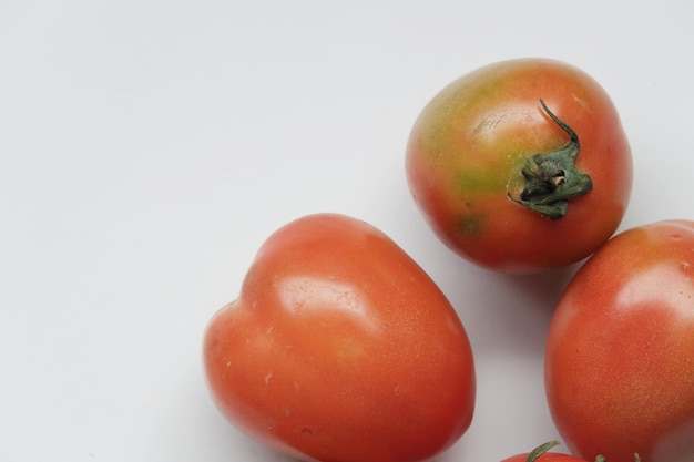 Red tomatoes on white isolated background