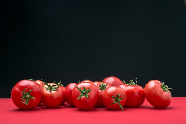 Red tomatos on color background