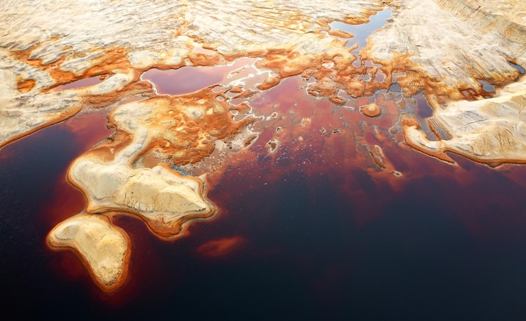 Photo red toxic water in the tank of the mining and processing plant.
