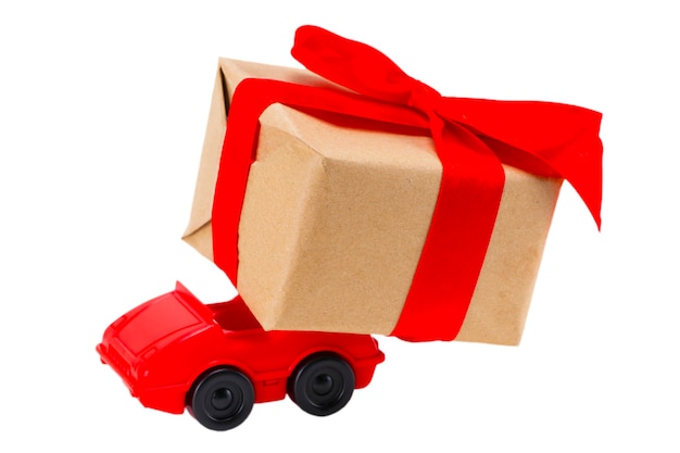 Red toy car delivering gifts box on a white background.