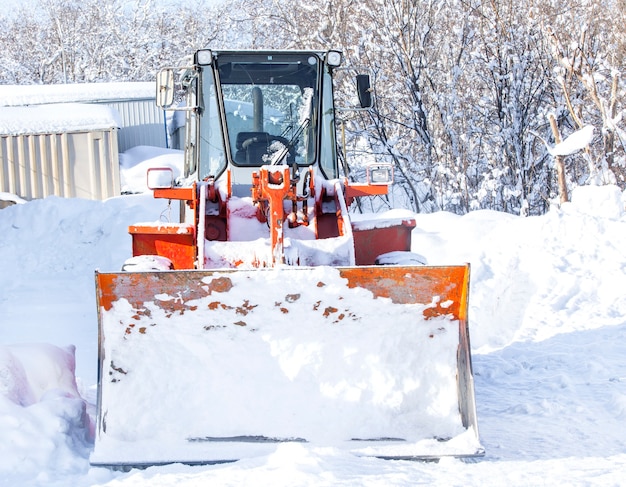 Red tractor for snow removal