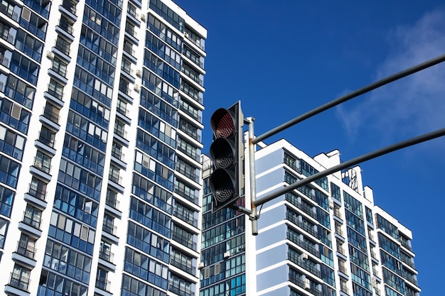 Red traffic light on the background of buildings