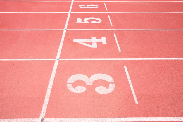 Red treadmill at the stadium with the numbering from three fourth five six