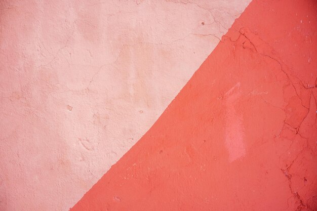 A red triangle is on a pink wall