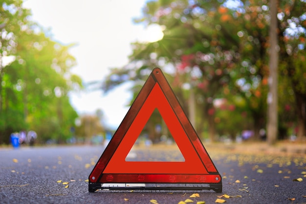 Red triangle, red emergency stop sign, red emergency symbol on road.