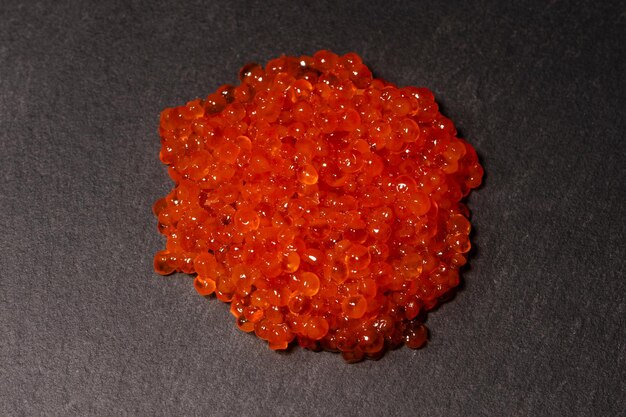 Red trout caviar on a black background