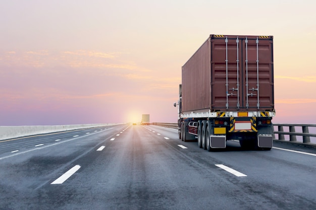 Photo red truck on highway road with container