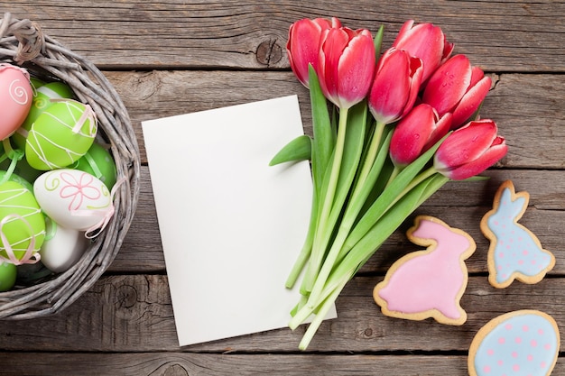 Red tulip flowers and Easter cookies and eggs