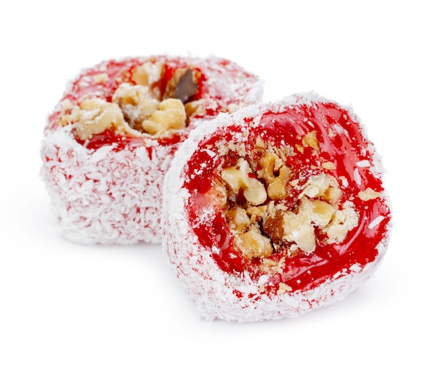 Red Turkish delight with nuts in powdered sugar isolated on white