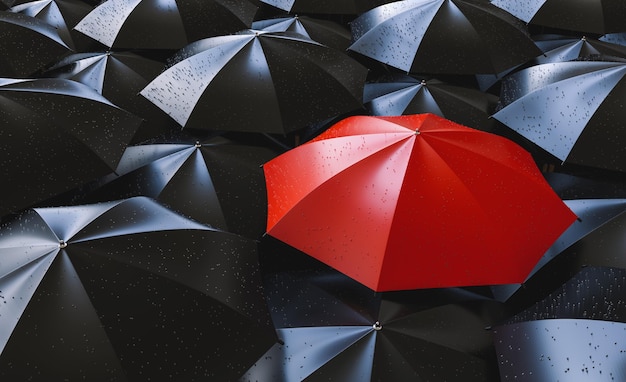 Red umbrella between black ones individuality and difference concept