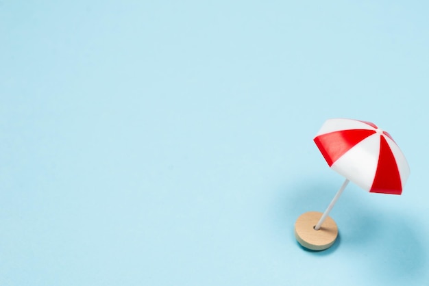 Red umbrella on a blue background. Copy space.