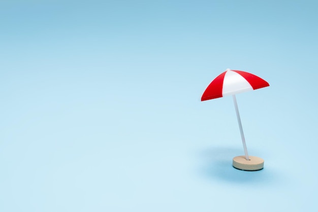 Red umbrella on a blue background. Copy space.