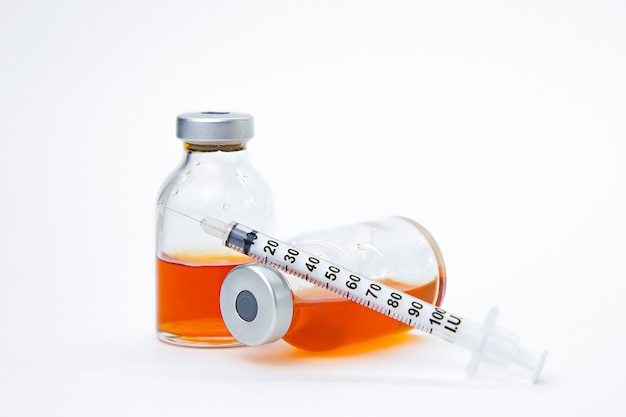 red vaccine bottle with syringe