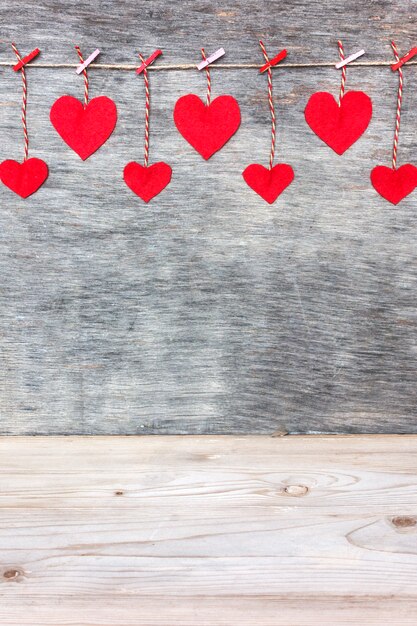 Red Valentine's love hearts on rustic driftwood texture background, copy space