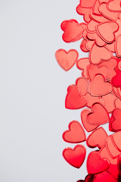 Red valentine's shiny glitter heart confetti background