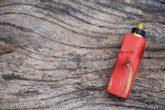 Red vaper on wooden background