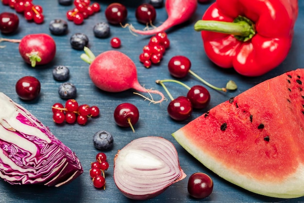 Red vegetables and fruits on a blue background