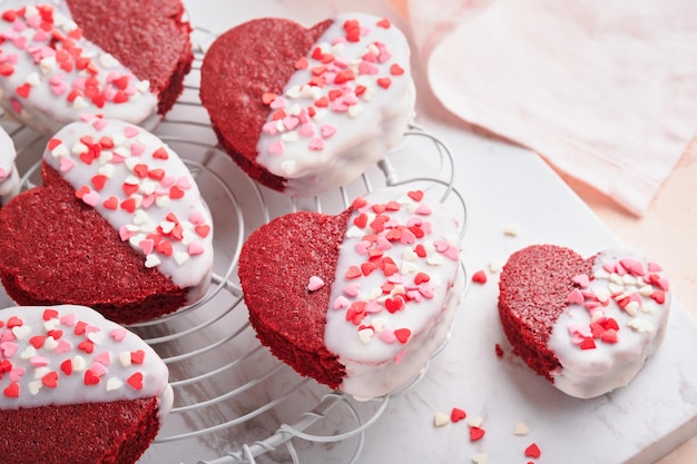 Red velvet or brownie cookies on heart shaped in chocolate icing on a pink romantic background Dessert idea for Valentines Day Mothers or Womens Day Tasty homemade dessert Cake for Valentines Day