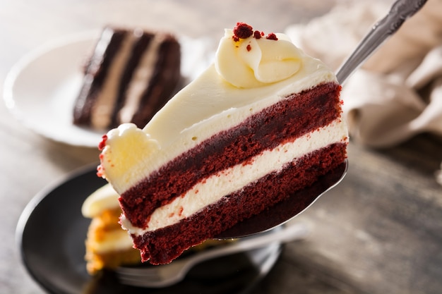 Red velvet cake slice on wooden table