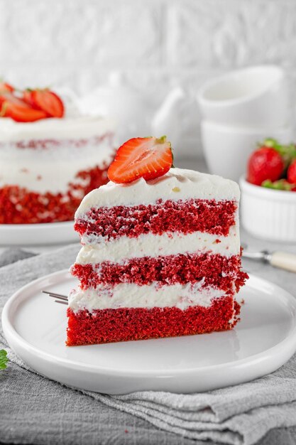 Red velvet cake with strawberries Layered cake from red sponge cakes and cream cheese frosting