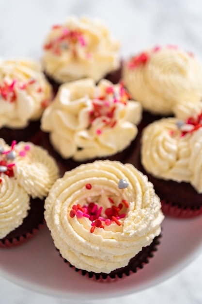 Red velvet cupcakes with white chocolate ganache frosting