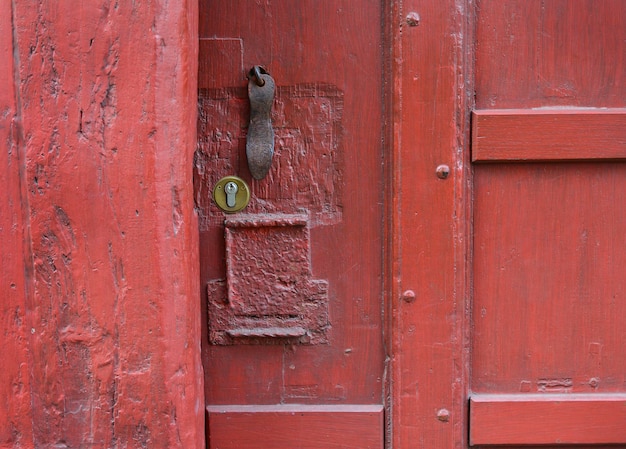 Red vintage wooden shabby door with a texture of cracks