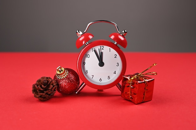 Red watch and gift wrap on a red background. 