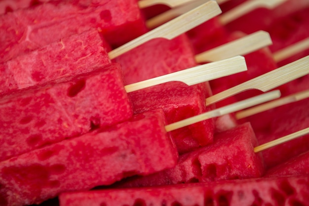 Photo red watermelons popsicles are colorful. concept summer hot weather eat melon