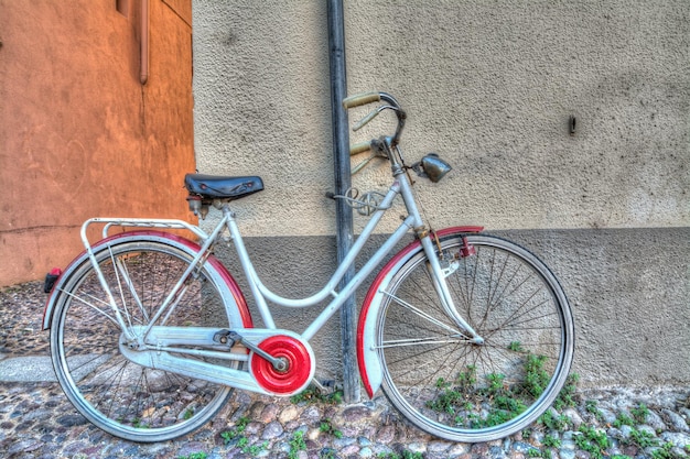 Red and white bike against the wall Processed for hdr tone mapping effect