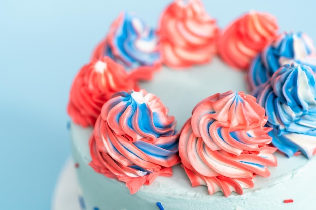 Red, white, and blue round cake frosted with buttercream frosting.